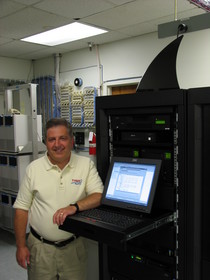 Photo of Trident Seafoods CIO Daniel Palumbo with IBM System i server.
