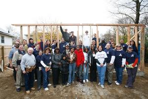 Pictured are members of LIBOR and Habitat for Humanity<br> working together to build a home for the Moore family.