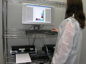 QualityLogic lab technician tests for inkjet cartridge page yield.