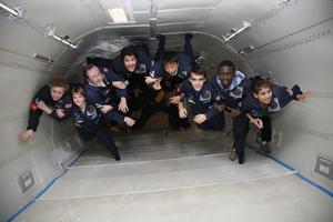 Interntational students link arms to commemorate 50th anniversary of the Space Age during ZERO-G flight; Students inspire tomorrow's explorers and education in science, math
