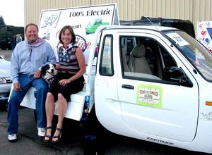 Montana Governor Brian Schweitzer, with wife Nancy and Border Collie Jag, first learned about the ZAP Xebra truck and sedan at the Fourth of July Parade in Butte this year. The Governor has mandated state agencies reduce fuel consumption by 20 percent in 2010.
