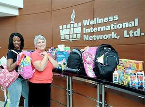 Wellness International Network employees Vonetta Fleming and Jeanette Camp gathered and delivered dozens of donated backpacks and school supplies to Rainbow Days, an organization that supports high risk children in the Dallas Metroplex.