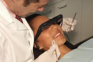 Patient watching InChairTV programming during dental visit