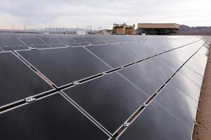 A row of solar panels reflects clouds and sunlight at the El Dorado Energy Solar facility near Boulder City, Nev., about 40 miles southeast of Las Vegas. 