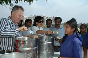 Serving lunch at a local school, chief globalization officer, Wim Elfrink, and Cisco volunteers in Bangalore, India raise awareness about the Hunger Relief campaign which provided lunches for more than 10,500 school children in 2007.