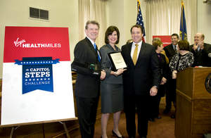 Virgin HealthMiles President, Sean Forbes (right), recognizes Gov. Butch Otter, First Lady Lori Otter and the State of Idaho's first place finish in the Capitol Steps Challenge, a two-week step competition between 14 U.S. governors to raise awareness of the correlation between increased physical activity and obesity prevention. Idaho will receive a $55,000 donation from Virgin HealthMiles to help combat childhood obesity.  