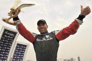 Austrian Hannes Arch takes home the first place trophy at the first stop of the Red Bull Air Race in Abu Dhabi on Saturday, April 18.