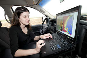 Karen Kosiba of the Center for Severe Weather Research accesses weather maps in real-time on her Lenovo ThinkPad laptop as she prepares to chase storms during the VORTEX2 tornado research project. 