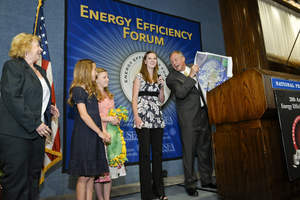 Clay Nesler, vice president of Global Energy and Sustainability for Johnson Controls adds a moment of levity at the 20th Annual Energy Efficiency Forum while recognizing teacher and student winners of the Igniting Creative Energy Challenge sponsored by Johnson Controls and the National Energy Foundation.