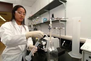 Hawaii Biotech's Marissa Torio finalizes the purification of the active dengue vaccine product which involves a buffer exchange into a stable solution suitable for long term storage. (photo courtesy of Hawaii Biotech, Inc.)
 
