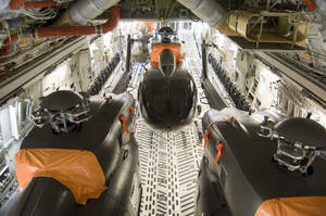 Three UH-72A Lakotas are secured inside of a C-17 Globemaster during a load test that validates the transportability of five UH-72As in a single C-17 aircraft.  EADS North America photo.
