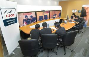 Team Cambodia and Team Thailand in the TelePresence room in Cisco's Bangkok office