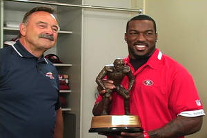 Hall of Fame linebacker legend Dick Butkus presents the second-ever professional Butkus Award(R) trophy to Patrick Willis of the San Francisco 49ers. Willis also won the collegiate Butkus Award while playing for the University of Mississippi. 