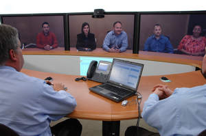 Bank of America associates in New York meet face-to-face with their teammates in Charlotte, N.C. via Cisco TelePresence to collaborate on an upcoming project. Photo Courtesy of Bank of America.