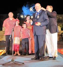 FIABCI Treasurer Yves Boussard transfers FIABCI World President Medal from Immediate Past President Lisa Kurrass (in background with her family) to FIABCI World President Enrico Campagnoli during Official Ceremony at the FIABCI World Congress in Bali, Indonesia.
