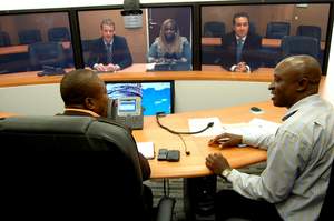 Den Sullivan, Cisco's CIO for Emerging Markets (far right) and Troy De Jong, Cisco's IT Manager for Africa Levant (far left), discuss Cisco TelePresence technology with journalists in Lagos