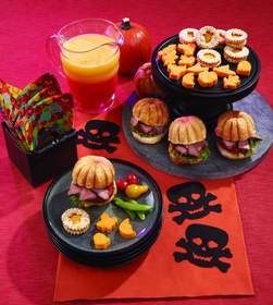 Sinister Sunset Cocktails, Spooky Crackers with Savory Cheese Spread, Magic Polenta Bites, and Flank Steak on Pumpkin-Shaped Rolls