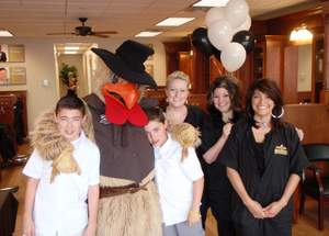 Welcoming guests to Roosters MGC Grand Opening celebration with Roosters' mascot are, from left to right, Connor and Grant Best, sons of store owners Tina and Sean Best; store manager Heather Rubin, and stylists Tammy Castro and Renee Hoffman.