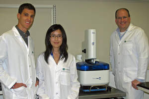 From Left to Right:  NanoProfessor Interns Troy Blume and Da In Lee with Dr. John Ireland, Director of the NanoProfessor Program and NanoInk's NLP 2000 Desktop Nanofabrication System.