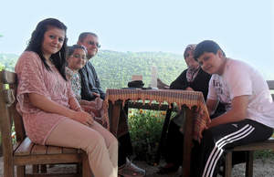 Using the Freedom(R) portable driver to power his SynCardia Total Artificial Heart, Turkish patient Omer Bayrak enjoys a meal in Istanbul with his daughters Zahide, 21 (front left) and Betul, 12, his wife Alime (back right) and his son Emre, 16.