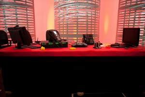 As seen on TLC Network's 'Cake Boss' TV show. Buddy Valastro's 'Technology Cake' made for business communications provider Avaya. Includes edible conference table (red) and working videoconferencing and phone equipment made from chocolate molding. Represents Buddy's new high-tech communications setup for his business.