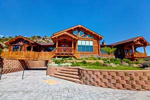 The 320-acre property includes a luxury log home and 14 other buildings. 