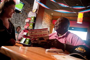 A veteran orders a free meal at Applebee's on Veterans Day, where all veterans and active duty military receive a free Thank You meal.