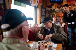 A veteran enjoys a free Thank You meal with fellow veterans on Veterans Day at Applebee's.