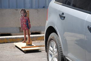 A cardboard cutout of a small child was used as one of the dynamic surprise events introduced to drivers while backing as part of the Exponent Backup Camera Display Evaluation research. 