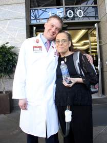 On Nov. 9, 2011, Tammy Lumpkins became the first SynCardia Total Artificial Heart patient on the West Coast to be discharged from the hospital to wait for a matching donor heart at home using the Freedom(R) portable driver. She is pictured with her cardiothoracic surgeon Dr. Michael Bowdish at Keck Hospital of USC.