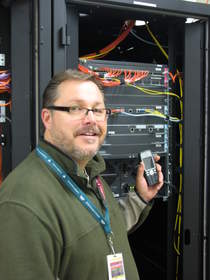 Kevin Somerville, manager, information technology at Woodstock Hospital shows off a Cisco Catalyst 6509-E Switch and Cisco Unified Wireless IP Phone (7925G)