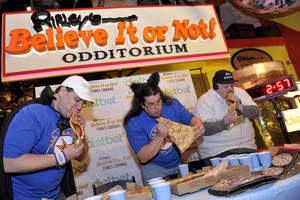Competitive eaters chowing down on giant pizza before doing a dietary 180 and going on a dietbet. 