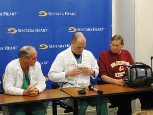 Cardiac surgeon Dr. Michael McGrath (center) holds the SynCardia temporary Total Artificial Heart during a news conference held at Sentara Heart Hospital on March 5 with cardiologist Dr. John Herre (left) and Total Artificial Heart patient John Martino (right). Mr. Martino became the first Total Artificial Heart patient to be discharged home from Sentara using the Freedom(R) portable driver on March 7.