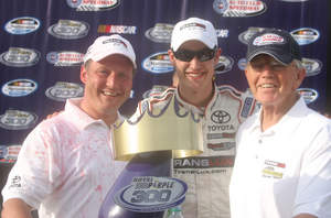 From Left to Right: J.M. Allain (President and CEO, Trans-Lux), Joey Logano (Winning Driver, Joe Gibbs Racing), Joe Gibbs (Owner, Joe Gibbs Racing)