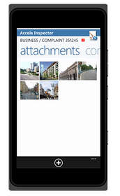 Windows Phone 7 with screen showing thumbnail photos of locations visited by inspector.