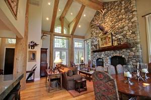 The five-bedroom home overlooks Trail Creek and has a view of the water from every bedroom. The living room has cathedral ceilings and a floor-to-ceiling river rock fireplace. 