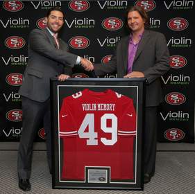 Jed York, CEO of the 49ers, shakes hands with Don Basile, CEO of Violin Memory