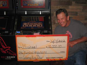 Michael, from Torrance, Calif., celebrates a $100,000 video poker progressive jackpot at Red Hawk Casino.