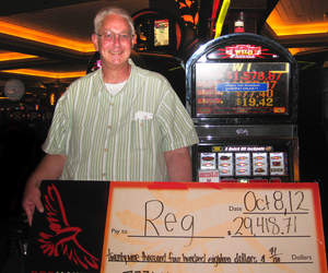 Reg, from Lincoln, Calif., celebrates a $29,418 penny slot jackpot at Red Hawk Casino.