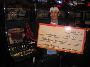 Quyen, from Sacramento, Calif., celebrates his $45,000 jackpot at Red Hawk Casino.