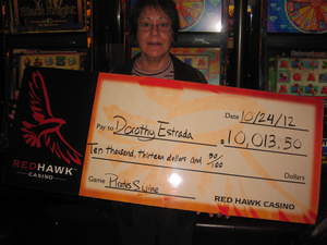 Dorothy, from El Dorado Hills, Calif., celebrates a $10,013 penny slot jackpot at Red Hawk Casino.