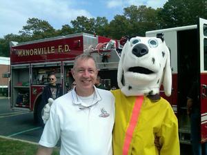 DVW franchisee John Ryley with Manorville Fire Dept. mascot.