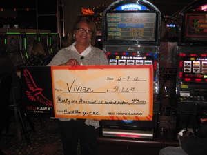 Vivian celebrates her $31,616 penny slot jackpot at Red Hawk Casino.