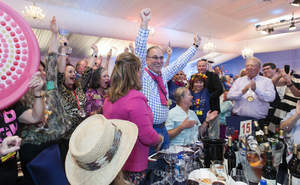 Bob and Karen Scott celebrate their winning bid of $750,000 for the fastest Ferrari ever built, the 2013 F12berlinetta, at the 2013 Naples Winter Wine Festival