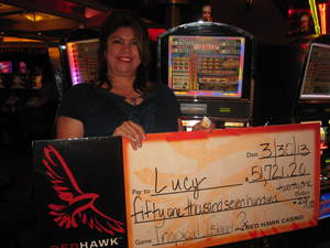 Lucy, from Sacramento, Calif., celebrates her $51,721 jackpot playing a five cent slot at Red Hawk Casino.