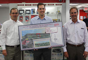 Wade Stufft, VP Operations (left), Loren Baidas, President (center) and Robert Baidas, CEO (right)holding the site plans for the newest General RV Center in Wixom, Mich. that will be completed in late 2014.