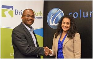 Bevil Wooding, Executive Director of BrightPath Foundation and Rhea Yaw Ching, corporate vice president of sales and marketing at Columbus sign MOU agreement.