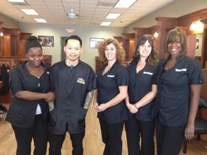 Roosters Men's Grooming Center team of professional barbers and stylists includes, from left, Shanelle Mitchel, David Nguyen, Store Manager Sibel Ariken, Laura Talleria and Browner Washington.