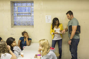 Tom Bury and Taniya Nayak gather insights from students at Benjamin Franklin Elementary School as to what they would like in their new lunchroom following the FrogTape Love for the Lunchroom makeover.