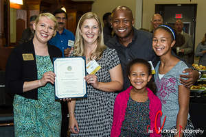 Cassia Martens of Maryland Delegate Cathleen Vitale's office, at left, presents a certificate of recognition to store owners Kim and Frankie Hall with their daughters Samantha and Kennedy. Photo provided by Richard Chomitz Photography.